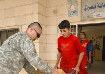 Multi-National Division - Baghdad Soldiers bring gifts to Victory Base Complex area school