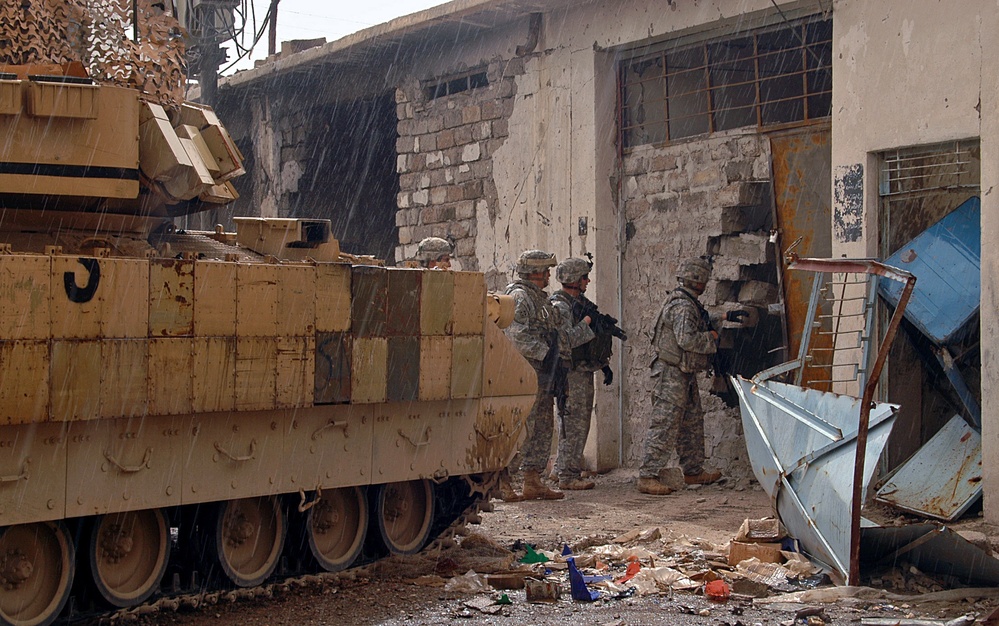 Infantry Soldiers conduct Mosul raid through rain and shine