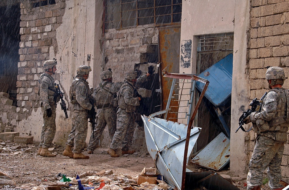 Infantry Soldiers conduct Mosul raid through rain and shine