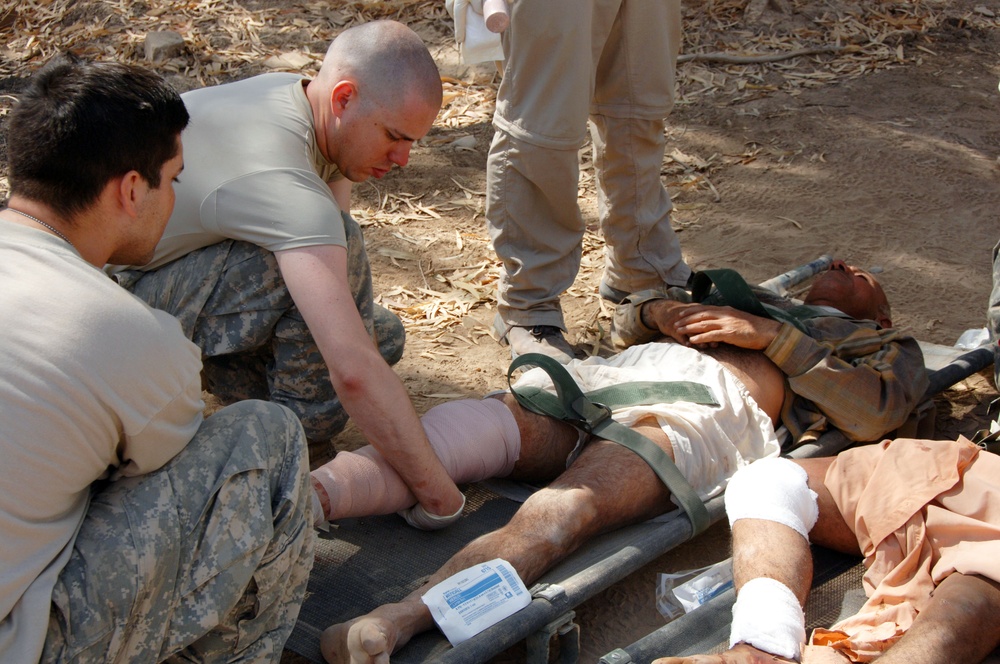 Soldiers perform medical treatment on suicide bomb victims
