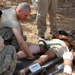 Soldiers perform medical treatment on suicide bomb victims