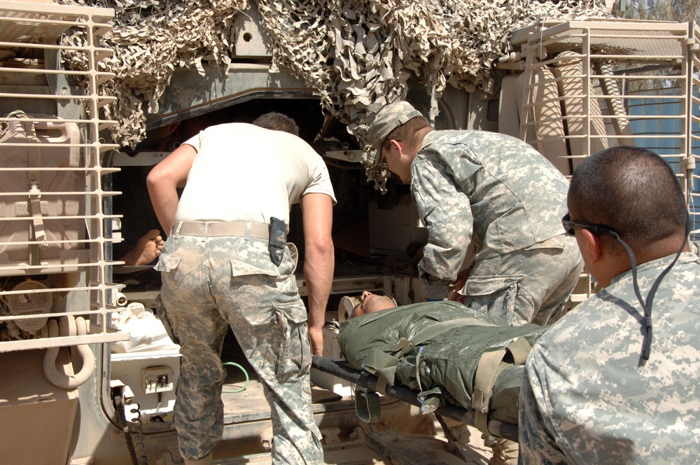 Soldiers perform medical treatment on suicide bomb victims