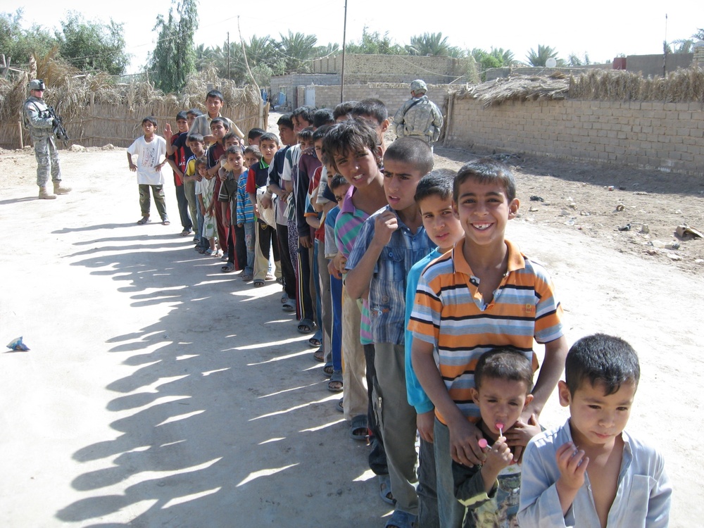 Soldiers hand out clothes, shoes to Iraqi children