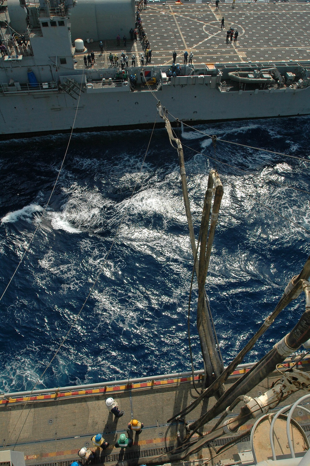 The USS Tarawa links up with USS Cleveland while underway