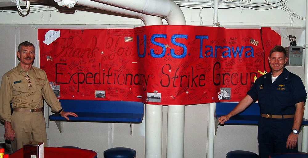 USS Tarawa Sailors display Christendom College "Thank You" banner.