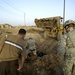 Soldier, Iraqi unearth weapons cache