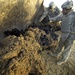 Soldier, Iraqi unearth weapons cache
