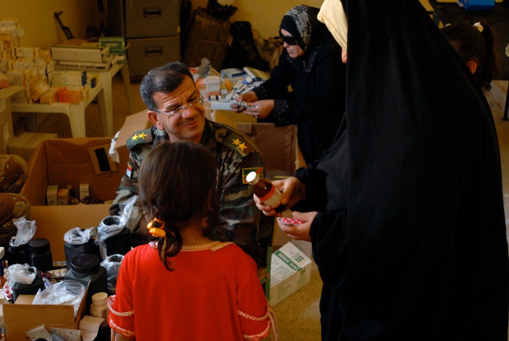 ISF, Coalition forces distribute food, toys