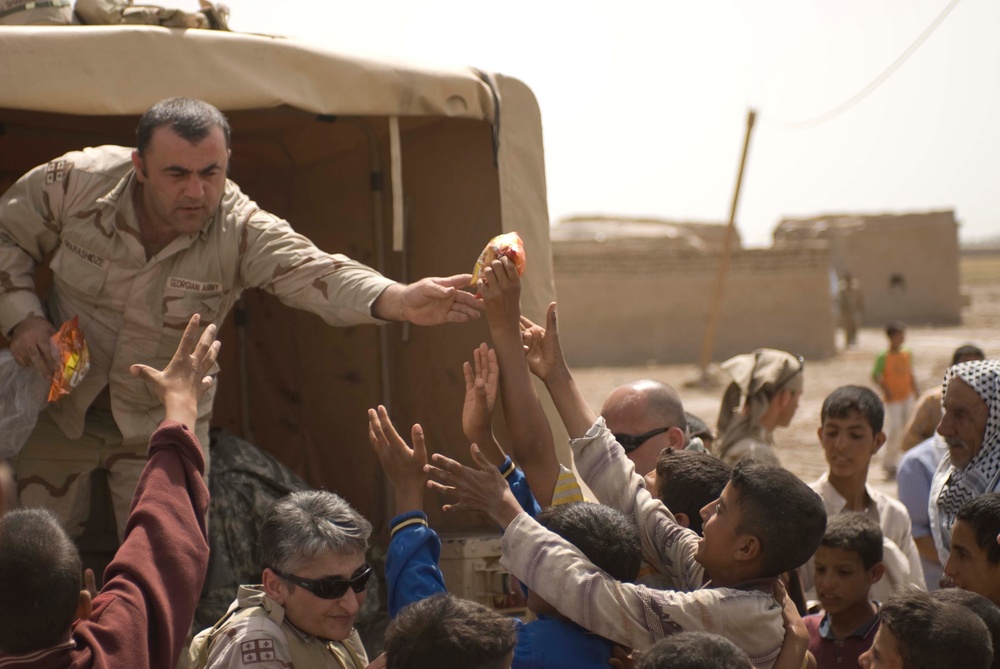 Coalition forces bring aid to village