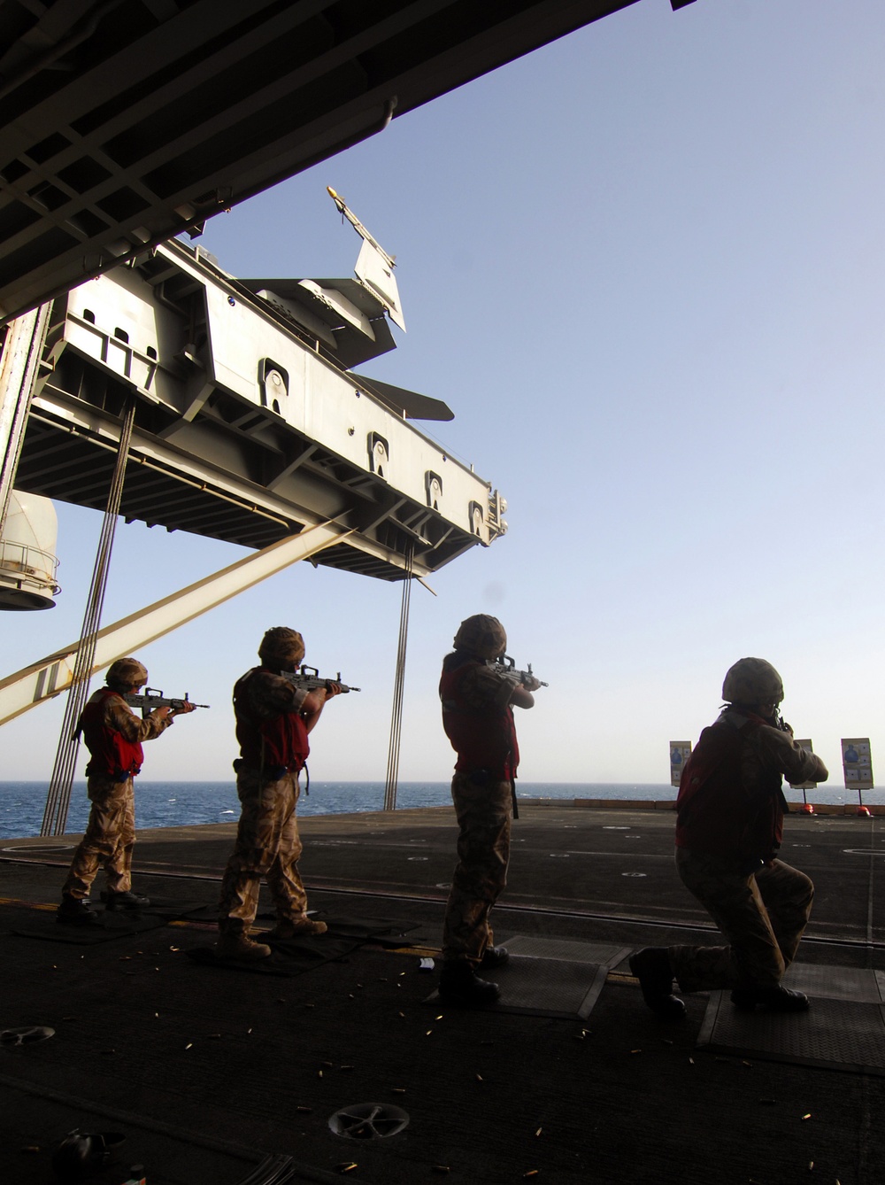 British Royal Navy sailors conduct weapons training aboard the USS Harry S. Truman
