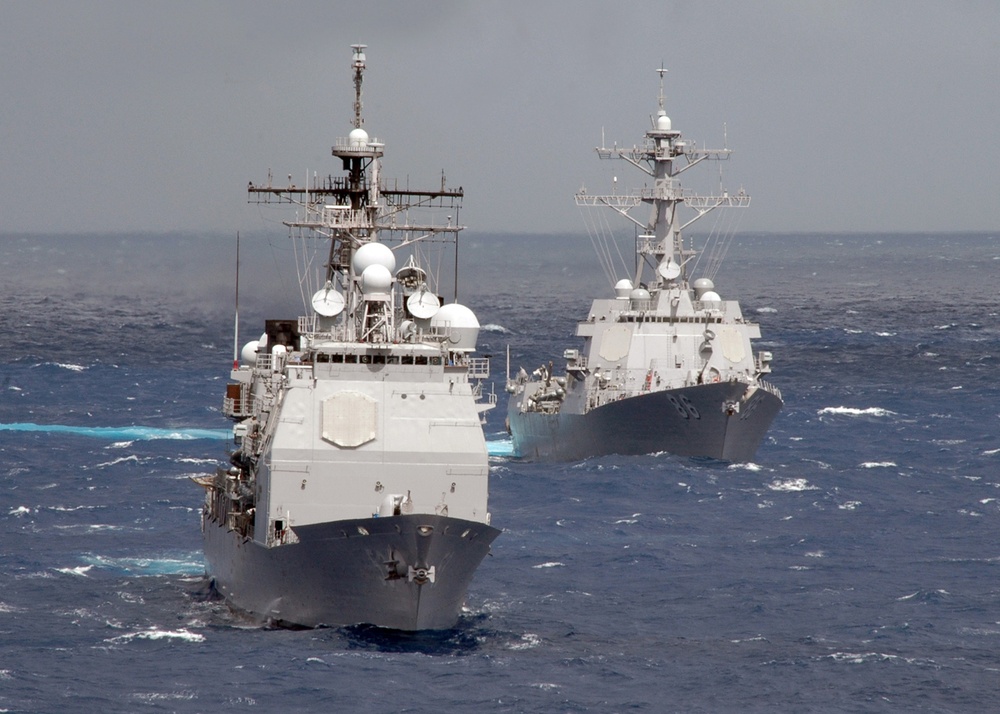 Guided-missile cruiser conduct a pass and review