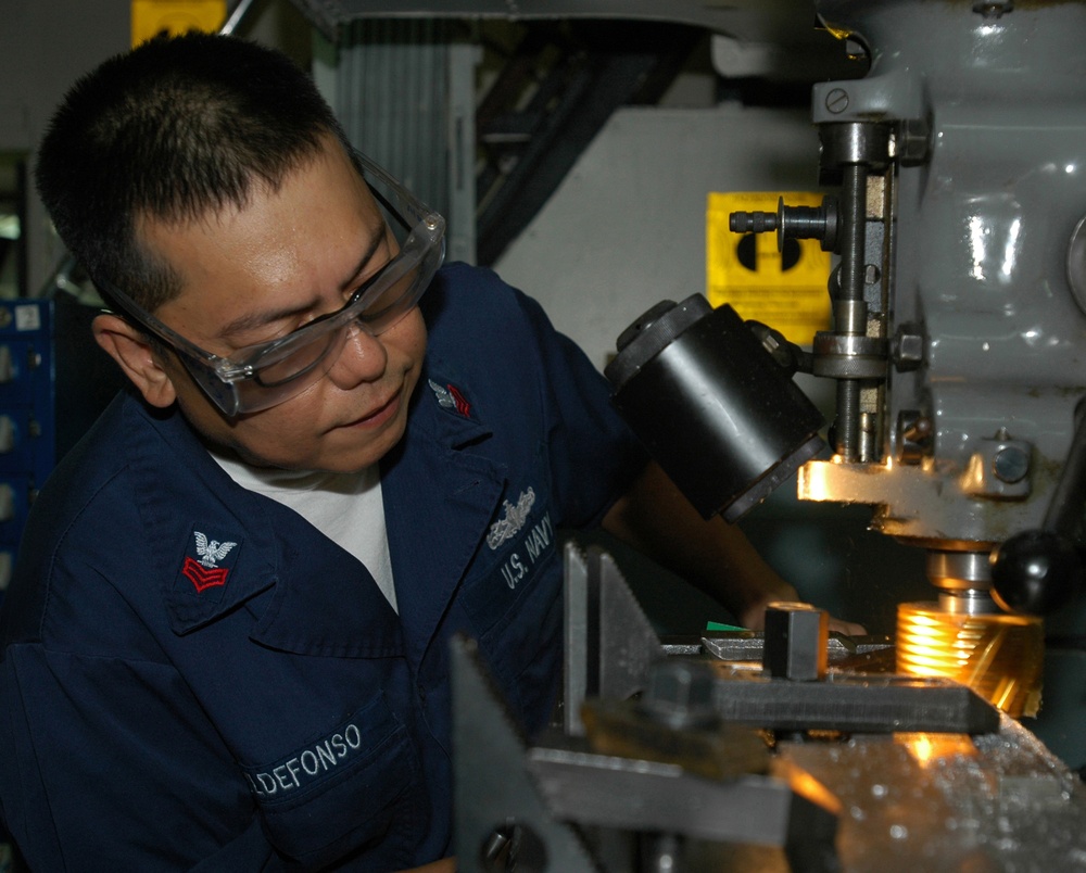 USS Nimitz Sailor constructs parts for fighter jet