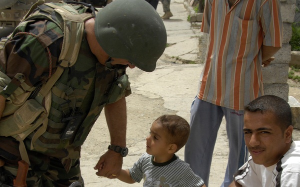 Iraqi Soldier Speaks to Child