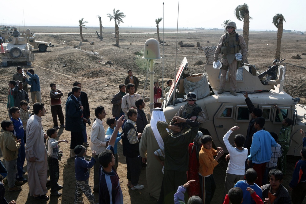 Marines hand out soccor balls during medical mission