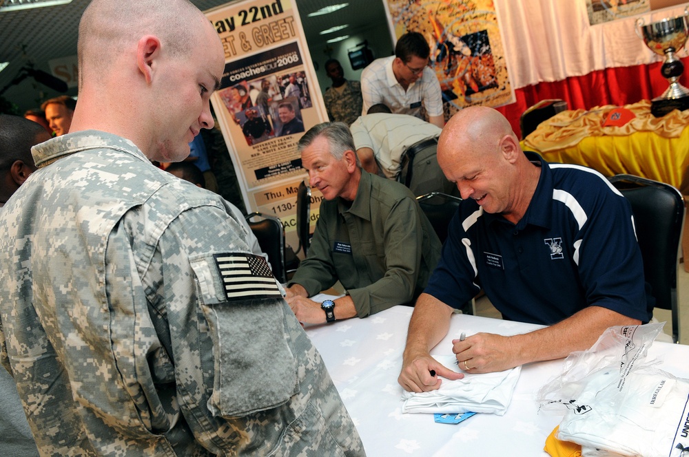 College football coaches visit fans in Qatar