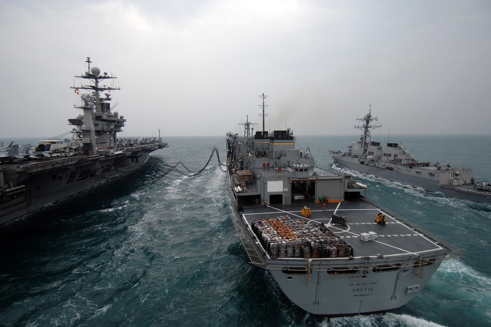 Carrier, destroyer conduct resupply mission while underway