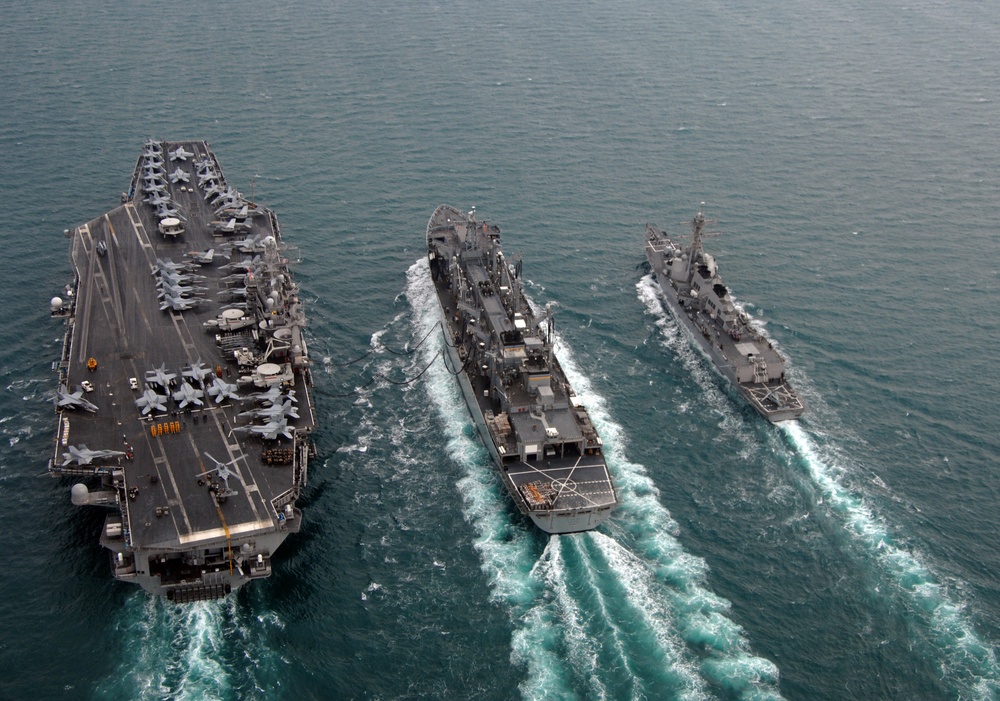 Carrier, destroyer conduct resupply mission while underway