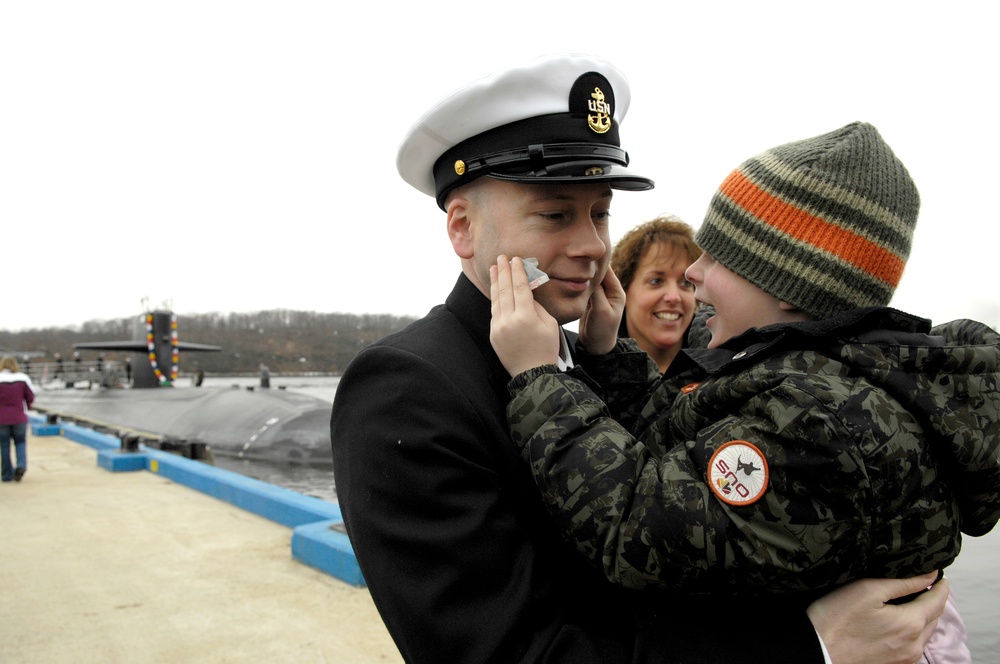 Father and son embrace after submarine's six-month deployment