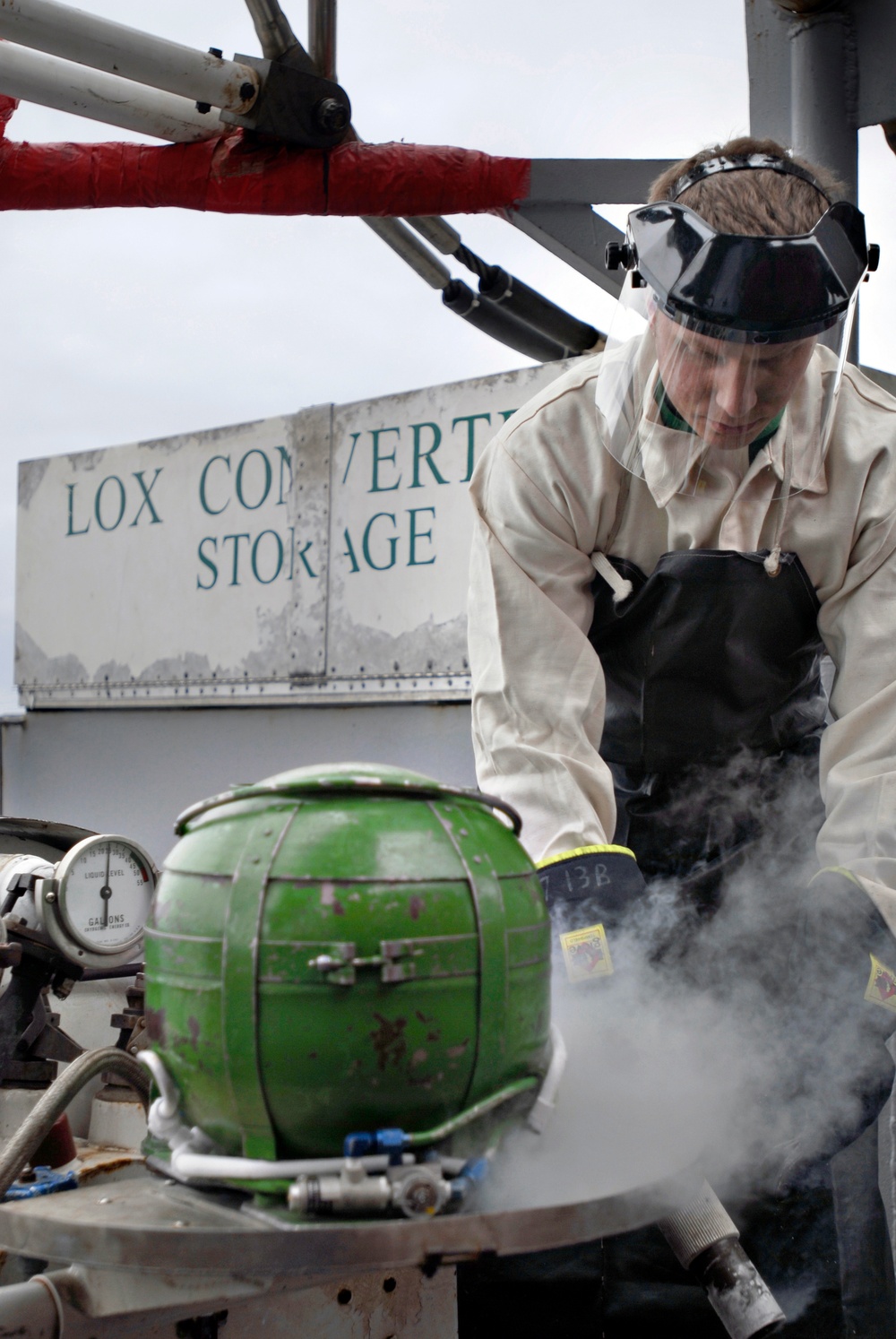 Sailor refills liquid oxygen tank aboard USS Nimitz