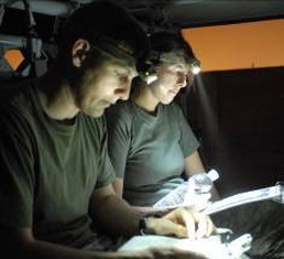 Task Force XII flight crews carefully map out mission details before moving infantry troops into dangerous areas