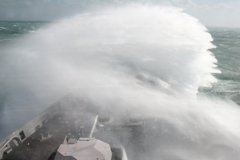 Waves crashing over USS San Antonio