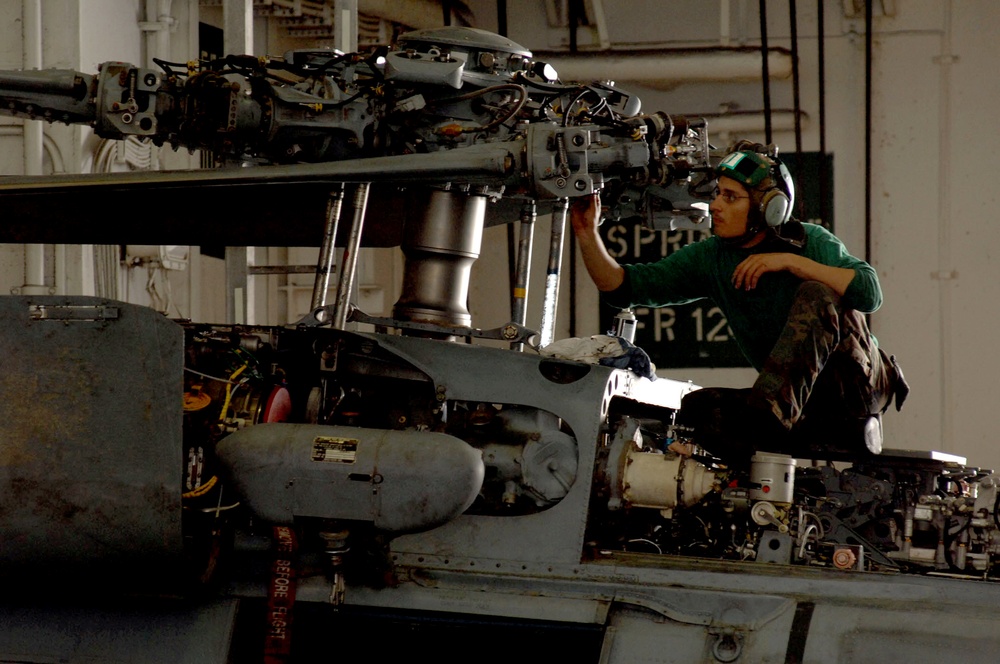 Repairing the blades of an SH-60 Seahawk