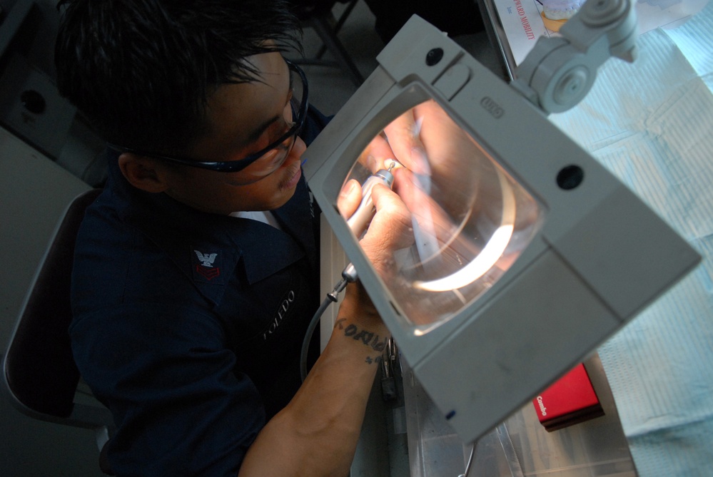 Sailors perform dental work aboard USS Ronald Reagan