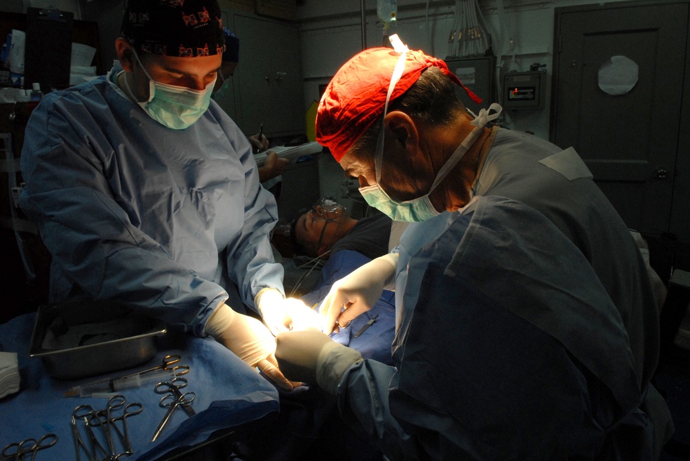 Surgeon works aboard USS Ronald Reagan