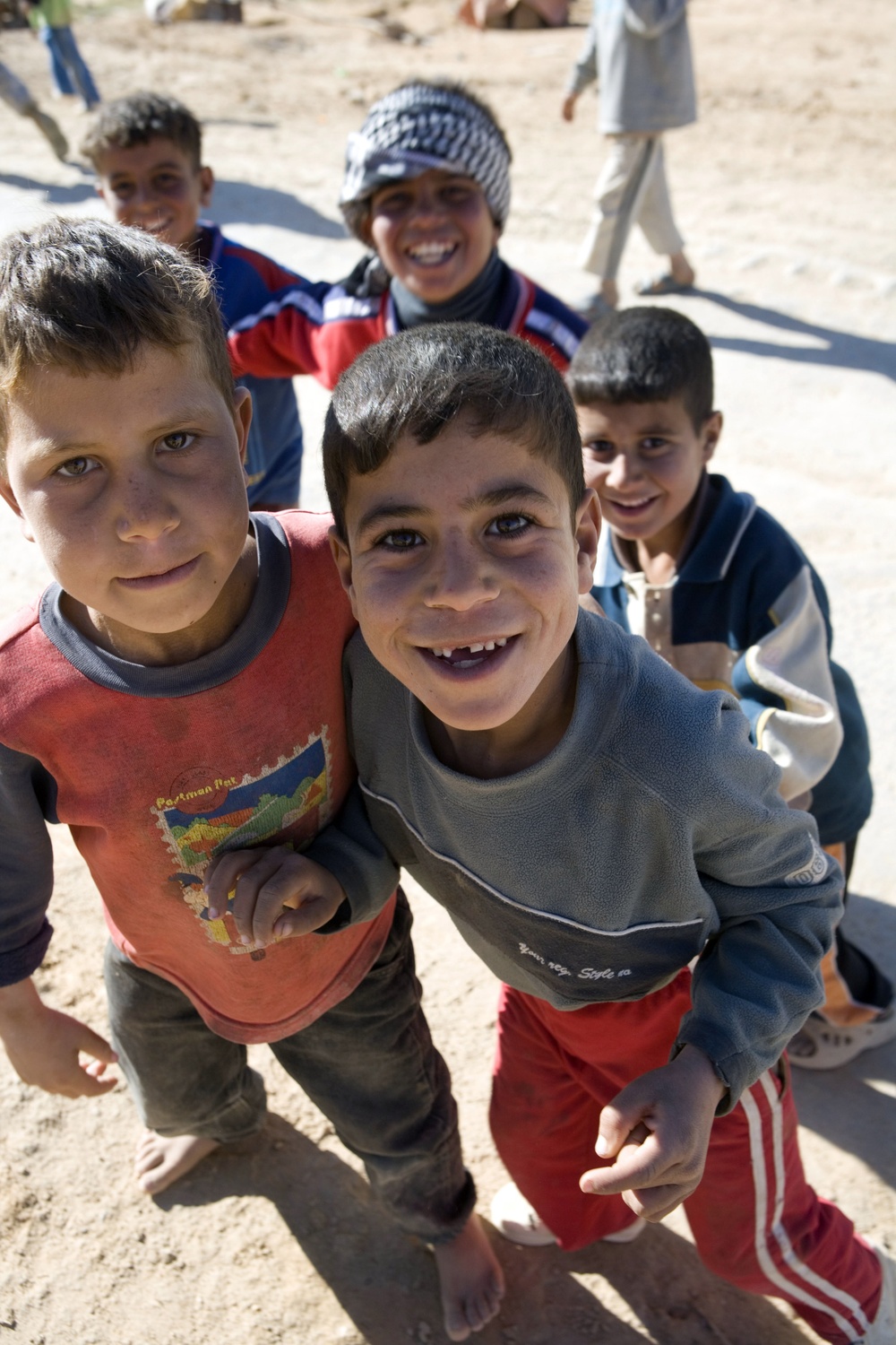 Children watch Marines patrol by