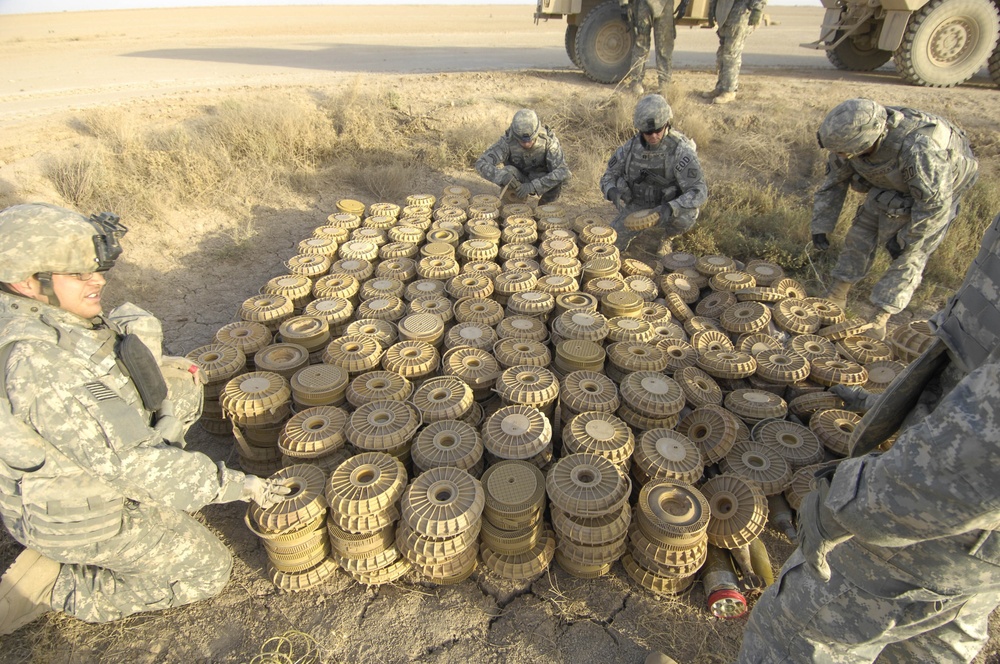 Soldiers prepare to destroy a cache of landmines