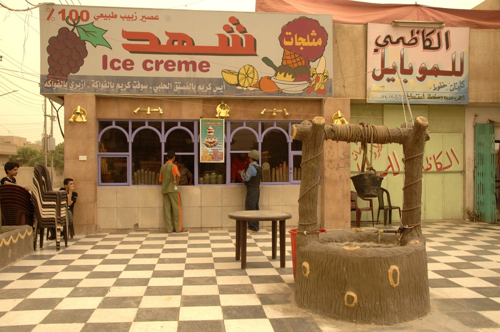 Iraqi Police Officer Stops at an Ice Cream Shop During Patrol