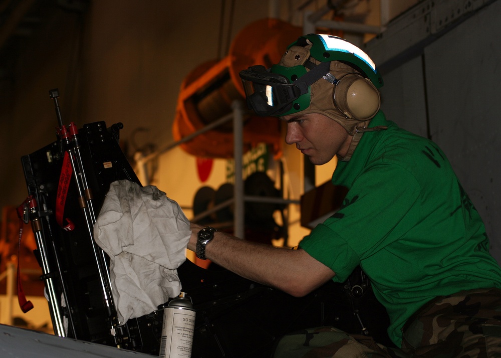 Sailor maintains equipment aboard USS Kitty Hawk