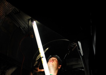 Sailor performs maintenance on a Prowler