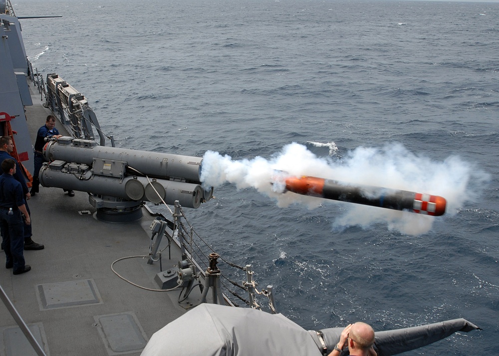 USS Mustin launches training torpedo