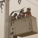 Local contract workers install power lines at Forward Operating Base Falcon