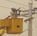 Local contract workers install power lines at Forward Operating Base Falcon