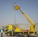 Local contract workers install power lines at Forward Operating Base Falcon