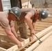 Seabees construct huts for Marine aide station