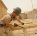 Seabees construct huts for Marine aide station