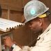 Seabees construct huts for Marine aide station