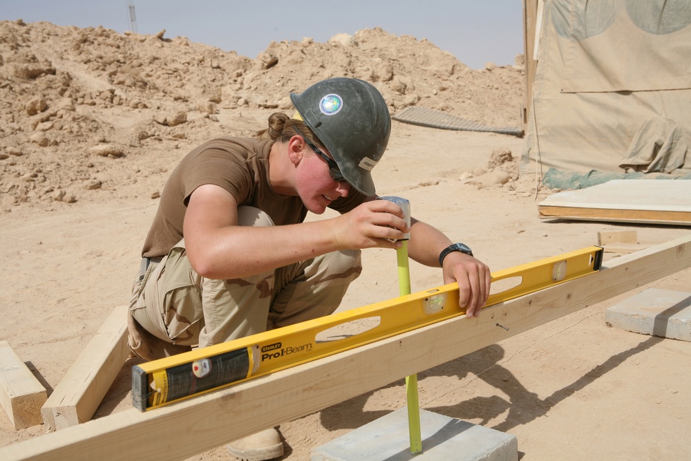 Seabees construct huts for Marine aide station