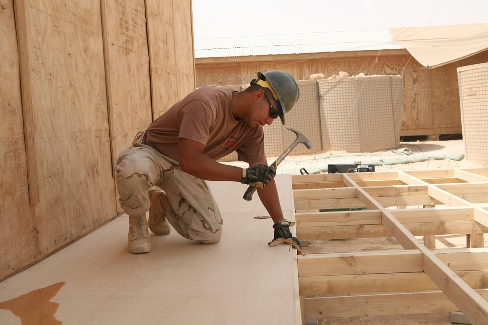 Seabees construct huts for Marine aide station