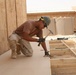 Seabees construct huts for Marine aide station