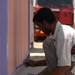 Iraqi contractor paints generator gates