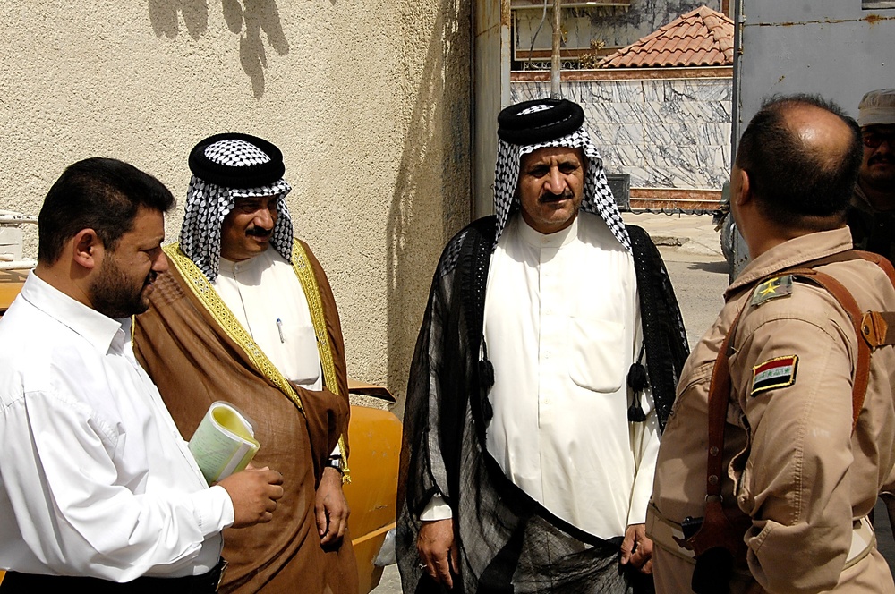 Iraqi Men Discuss Assessment of Sewer Plant Repair