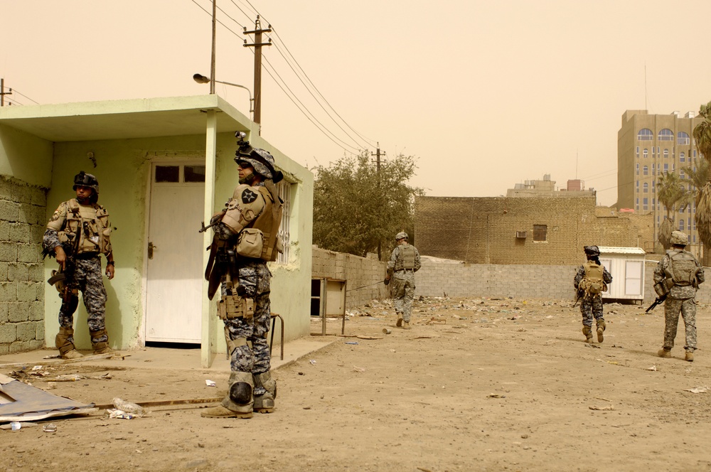 U.S. Iraqi national police, army, patrol streets, look for caches