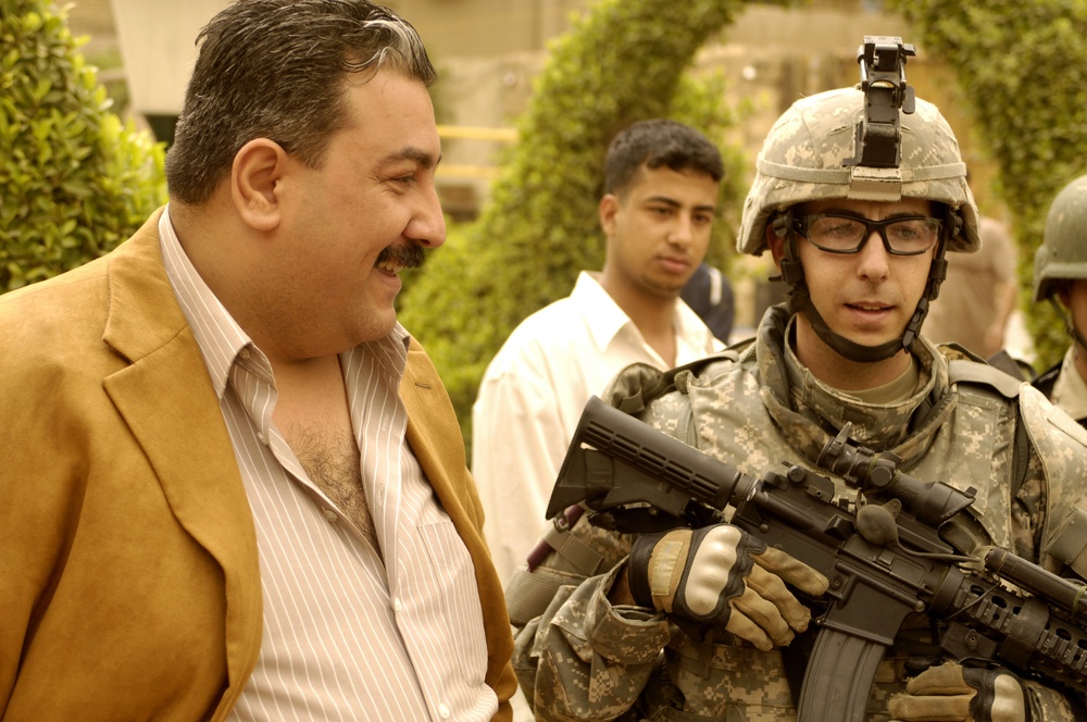 U.S. Iraqi national police, army, patrol streets, look for caches