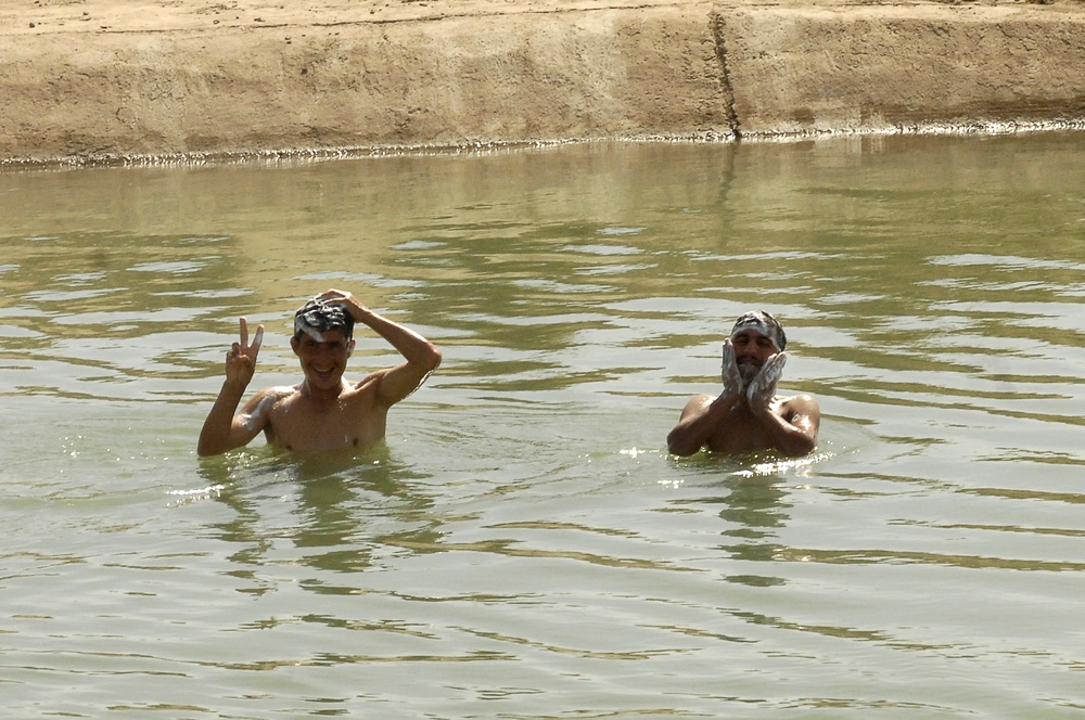 Iraqi Boys Clean Up in Canal During Operation Dimaggio