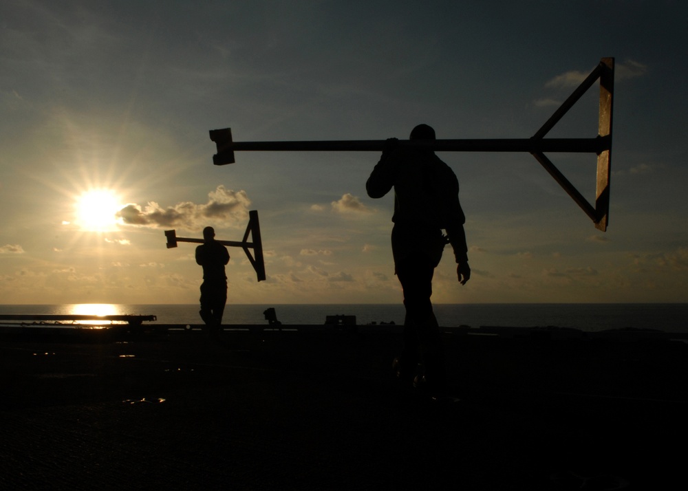 USS Abraham Lincoln Sailors manage flight deck