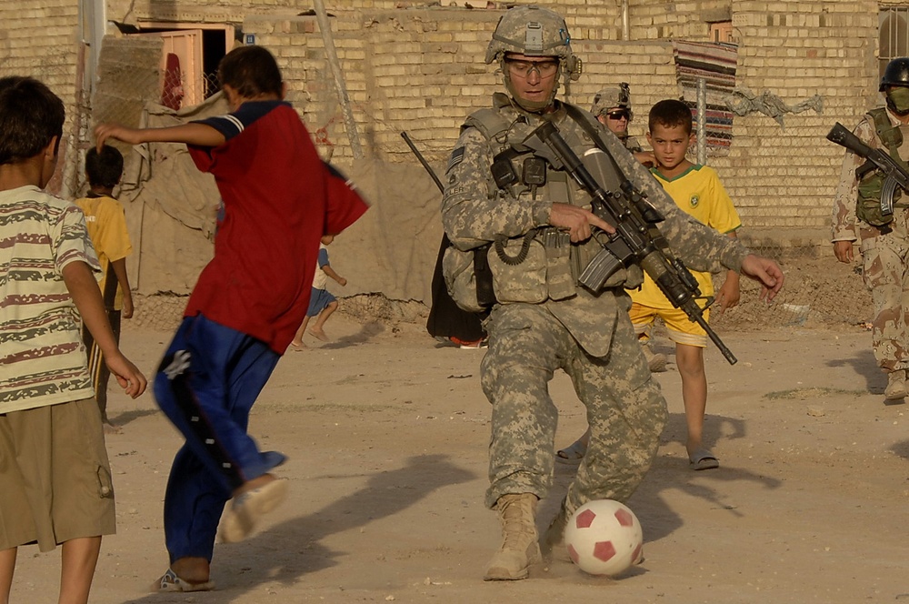 U.S. Army Sgt Joins Iraqi Boys in a Game of Soccer